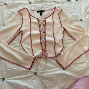 Cream lace-up long-sleeved shirt.